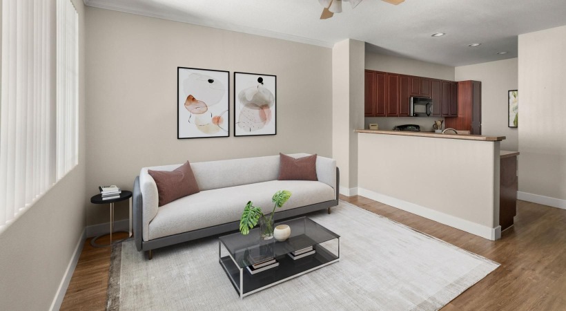 a living room with a couch and a fan